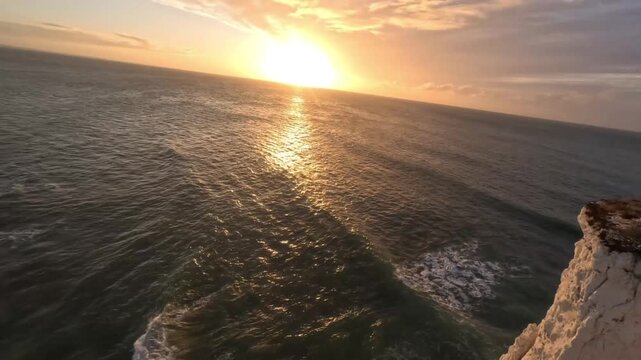 Dynamic FPV Drone Flight Alng White Chalk Coastal Clifs at Sunset