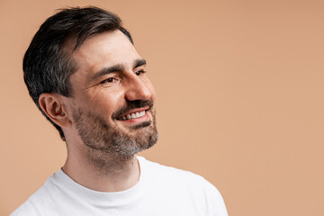 Fototapeta premium Happy smiling middle aged man looking away with positive expression