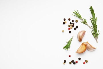 Fresh garlic, peppercorns and rosemary on white background, flat lay. Space for text