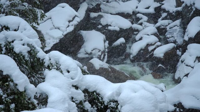 Chilly mountain streams wind past jagged stone formations gradually freezing. Ice cold mountain rivers meander through harsh and uneven rugged rocky landscapes seamlessly. Yosemite National Park