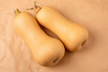 Two butternut squash on brown paper background