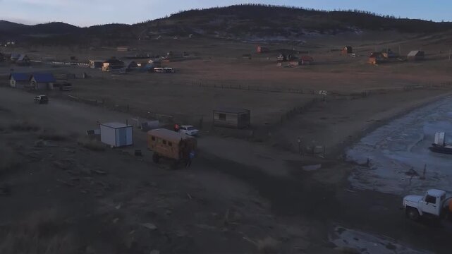 Rural Siberian village life with hovercraft and trucks on icy terrain