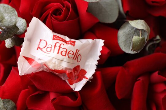 KYIV, UKRAINE - FEBRUARY 14, 2026 Raffaello candy on a red roses bouquet. Raffaello is a spherical coconut almond confection