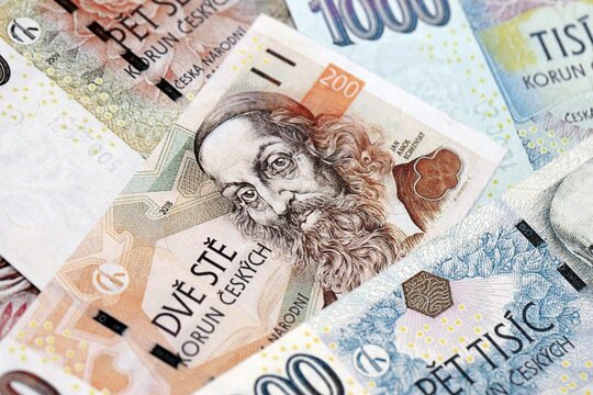 Czech koruna paper banknotes pile on table. Czech Republic CZK currency money bills in big amount. Concept of economics, taxation and banking in Czech Republic