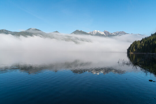 Canada, BC, Vancouver Island, Telegraph Cove.  Fog lays over the face of Nimpkish Lake.  