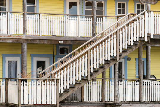 Canada, BC, Alert Bay.  Wooden walkway and stairs accessing Two story wooden apartment building.