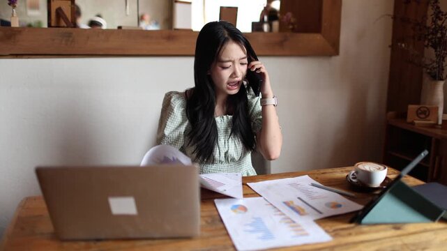 Frustrated manager sitting at office desk with laptop, stressed by business problems, fatigue, anxiety, and workplace pressure during difficult workday.

