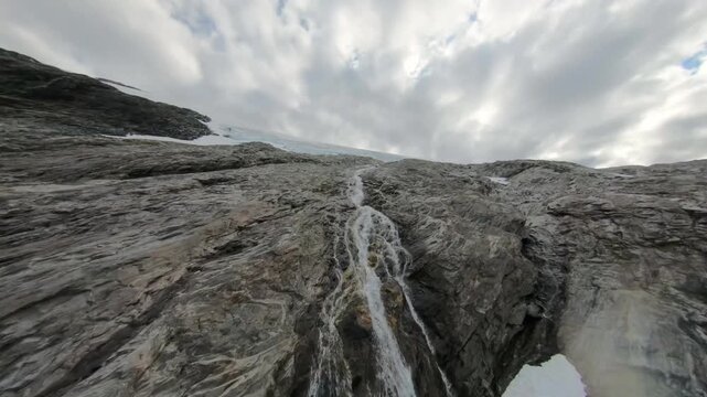 Moody Low Angle View of a Thin Stream Cascading Over extured Gray Rocks