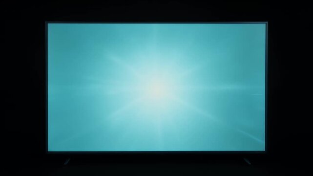 Television screen displaying a bright, stylized, blue and white sunburst effect