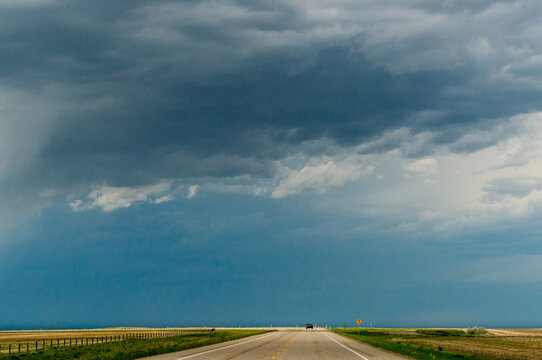 Canada, Alberta, Mossleigh.  Long, straight, lonely prairie road. 