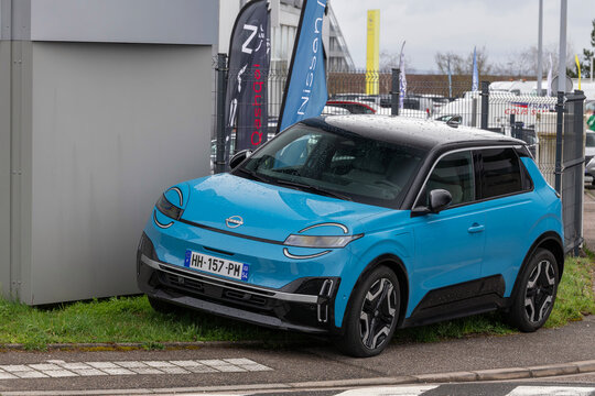 Laxou, France - March 14th 2026 : View on a blue Nissan Micra finished in Azure blue with a black roof parked on a street.