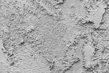 Obraz premium Description: Close-up photo of gray cement or concrete surface with bumpy grainy texture and smoother areas showing natural wall pattern, selective focus