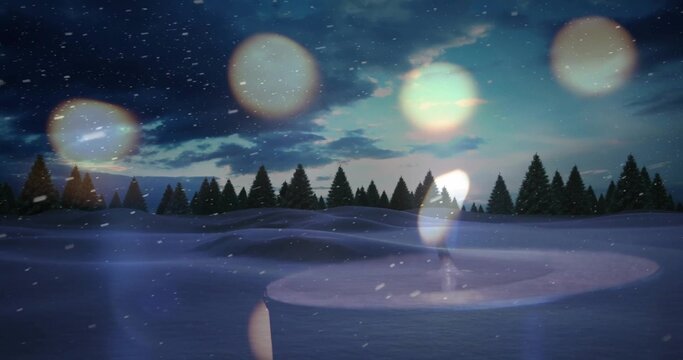 Showing round snow basin catching dim glow in snow field, with pine trees, snowflakes, lens flares