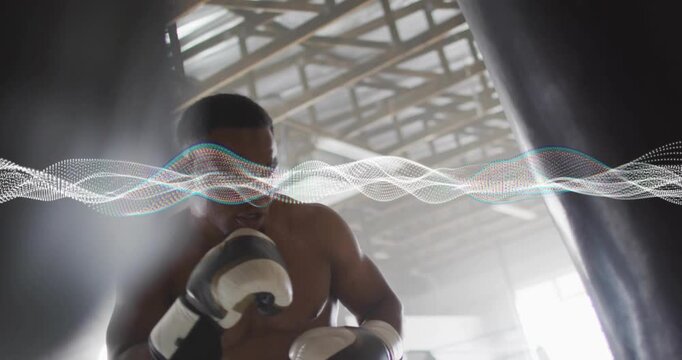 Male boxer assuming guard, punching heavy bag for training, animated wave sweeping across frame