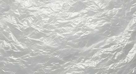 Obraz premium Textured background of crinkled translucent plastic wrap, creating a shimmering, abstract surface with light reflections