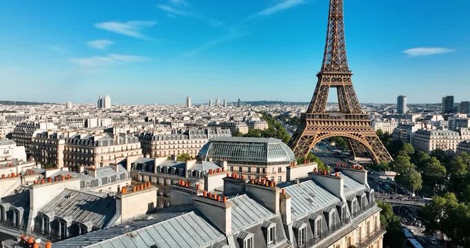 Iconic Eiffel Tower overlooking Paris rooftops under clear blue sky