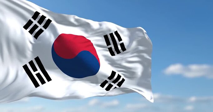 South Korean flag Taegeukgi waving under bright blue sky