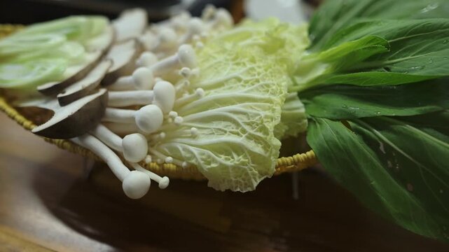 Homemade Hotpot Spread Napa Cabbage Enoki Laid Out On Wooden Board In Cozy Kitchen, Home Cook Arranging Greens And Shiitake, Warm Ambient Light, Intimate Closeup Emphasizing Texture And Freshness