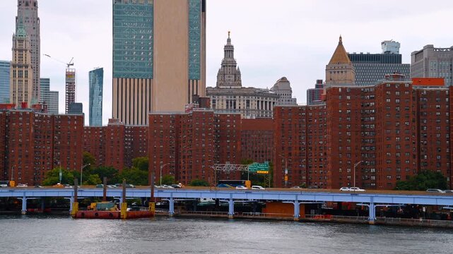 New York, USA, 5 May 2025: Manhattan residential skyline with red brick buildings and skyscrapers. Urban landscape showing brick apartment complexes along the East River with Manhattan skyscrapers
