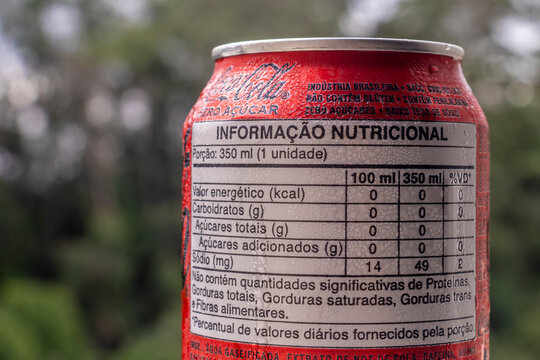 Sao Paulo, Brazil, January 26, 2026. Close-up of a Brazilian Coca-Cola Zero Sugar can, focusing on the nutritional information label. The can is covered in condensation droplets.