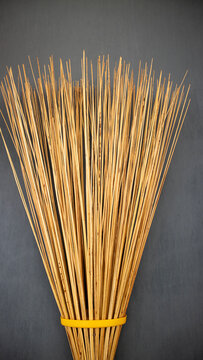 Traditional Indonesian broom made from dried coconut leaf sticks or sapu lidi. Natural household cleaning tool commonly used in Southeast Asia for sweeping floors and yards