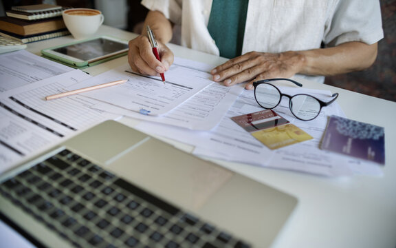 close up shot, asian man doing online business, E commerce. checking business document, contract, bank statement and passbook. Investing in business via credit card loans