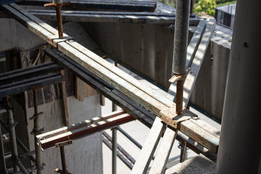 Jakarta, Indonesia - March 16, 2026: Technical detail of metal scaffolding joints and support posts installed on the concrete structure of a building project in Jakarta