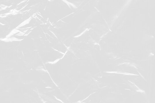 Crinkled polyethylene wrapping material. Glossy texture with scattered sharp folds. Isolated transparent background PNG cutout. Ideal for modern digital art overlays. 