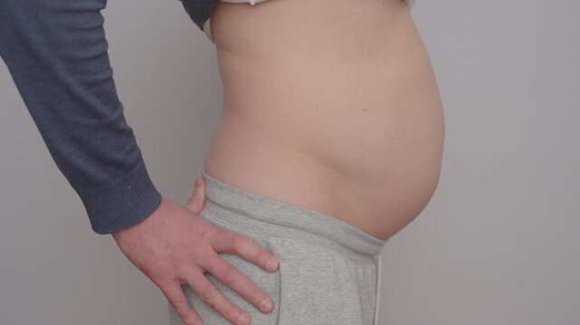 Man Showing Lumbar Hyperlordosis | Excessive Lower Back Curve and Belly Posture | Side View Close-Up on Neutral Background