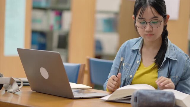 Student studying at library desk academic environment informative content focused view learning concept