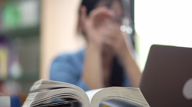 Studying in a quiet library student focused on learning indoor environment intellectual engagement close-up view
