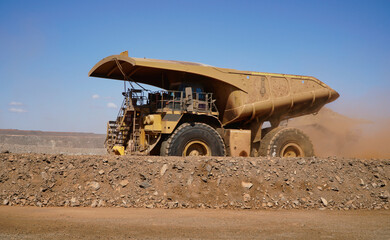 Western Australia mining town of Kalgoorlie a heavy mining dump truck hauling dirt across open pit © electra kay-smith