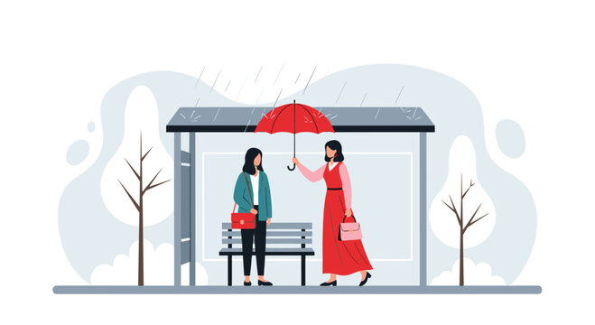 Kind woman holds a red umbrella to share shelter with a stranger at a public bus stop during a rainy day in the city park.