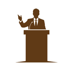 man in suit speaking at a podium with microphone