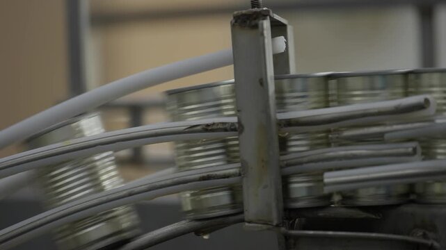 Canned food manufacturing industry, canned products moving rapidly along an automated conveyor machine on the production line