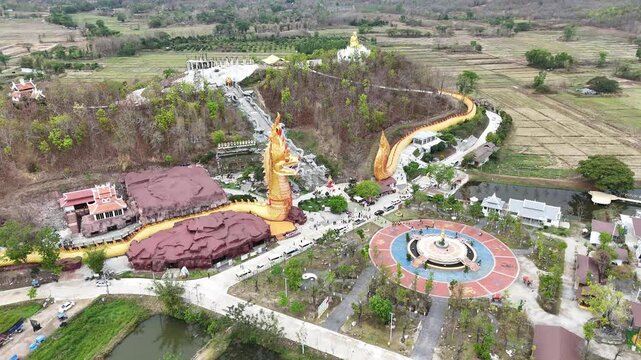 Aerial view of Wat Pa Phutthachinwong temple in Phu Kamyao District, Phayao province of Thailand. This temple has a Thailand's most biggest Naga sculpture (909 m long).