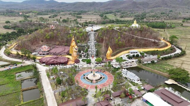 Aerial view of Wat Pa Phutthachinwong temple in Phu Kamyao District, Phayao province of Thailand. This temple has a Thailand's most biggest Naga sculpture (909 m long).