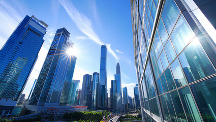 Modern Skyscrapers Rise Against a Bright Blue Sky with Sun Flare ©  Blar Studio