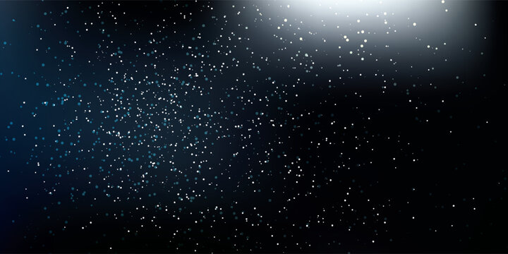 Abstract particles floating in dark space with light effect.