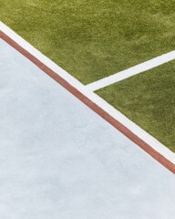 Fototapeta premium Empty Sports Field with Green Grass and White Markings Close Up Detail showing Turf and Border at an Outdoor Complex for Athletic Training Background