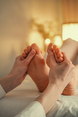 Professional reflexology foot massage in a peaceful spa setting