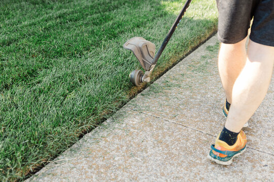 Man using electric edger to care for lawn