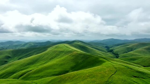 A stunning landscape of green rolling hills under a cloudy sky, creating a serene and captivating scene. The scene evokes tranquility and natural beauty