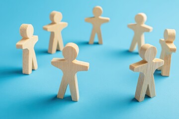 Team Circle: Abstract wooden figures arranged in a circle, symbolizing unity and connection, against a bright blue backdrop, evoking concepts of teamwork and collaboration.