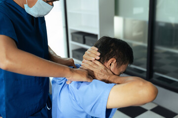 Fototapeta premium Physical therapist helping patient with shoulder rehabilitation exercise in clinic. Healthcare treatment, physiotherapy recovery, injury therapy