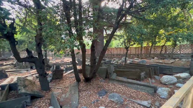 Cinematic 4k video of ancient Kalash Wooden Coffins in an Open Air Graveyard, Bumburet Valley, Chitral, Pakistan, Cinematic Pull Back Shot and panning to left