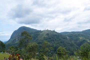 Obraz premium Dramatic view of Ella Rock mountain in Sri Lanka at dawn. Majestic cliff silhouette during pre-dawn twilight with misty valleys and soft blue hour light, famous trekking destination.