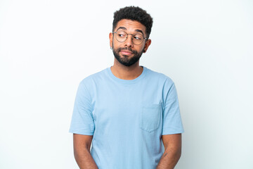 Young Brazilian man isolated on white background making doubts gesture looking side