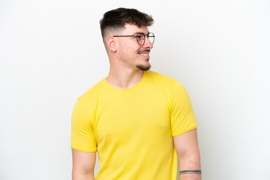 Young caucasian handsome man isolated on white background looking side