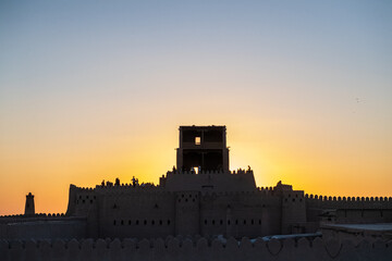 Obraz premium Backlit image of the famous Kuhna Ark, a fortified citadel in the city center of historic Khiva.